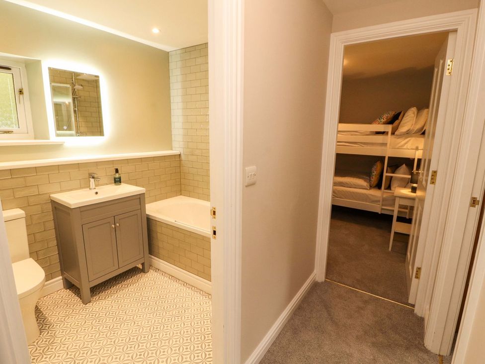 A bathroom with a sink and bathtub at Swallow's Nest in Keswick