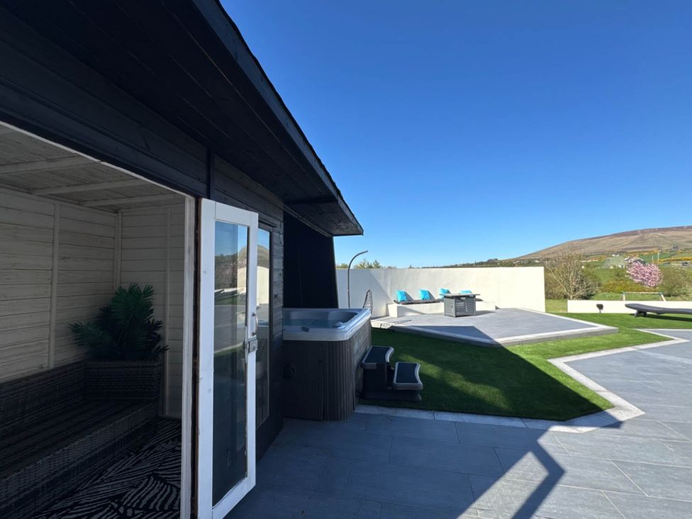 An outdoor area with a hot tub and seating at Jeannies retreat at little lake fb
