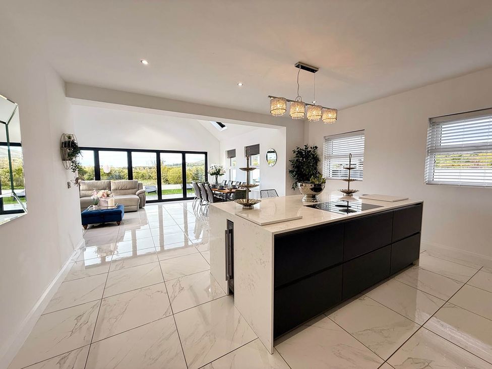 An open plan kitchen and dining area with a kitchen island at Jeannies retreat at little lake fb