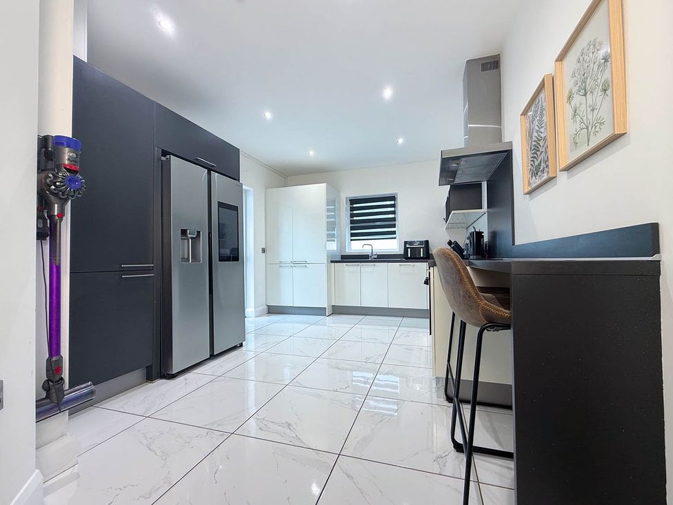 A kitchen with appliances and seating at Jeannies retreat at little lake fb