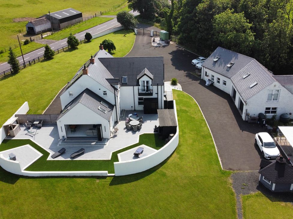 An outdoor view of a house with a garden and patio at Jeannies retreat at little lake fb