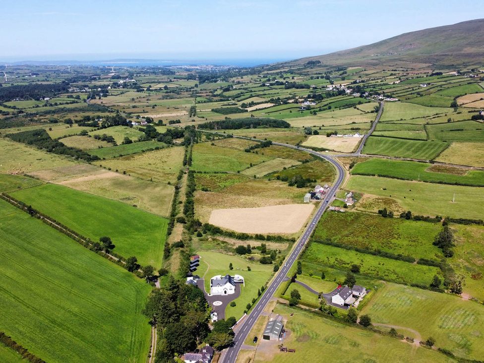 An aerial view of fields, road, and houses at Jeannies retreat at little lake fb