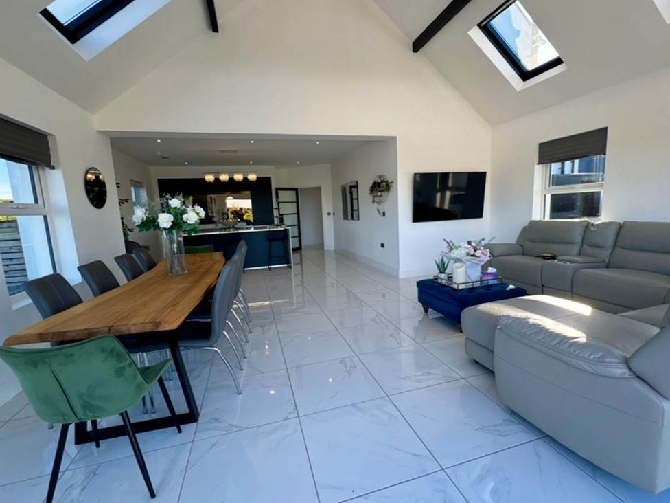 A living room with a dining area and kitchen island at Jeannies retreat at little lake fb