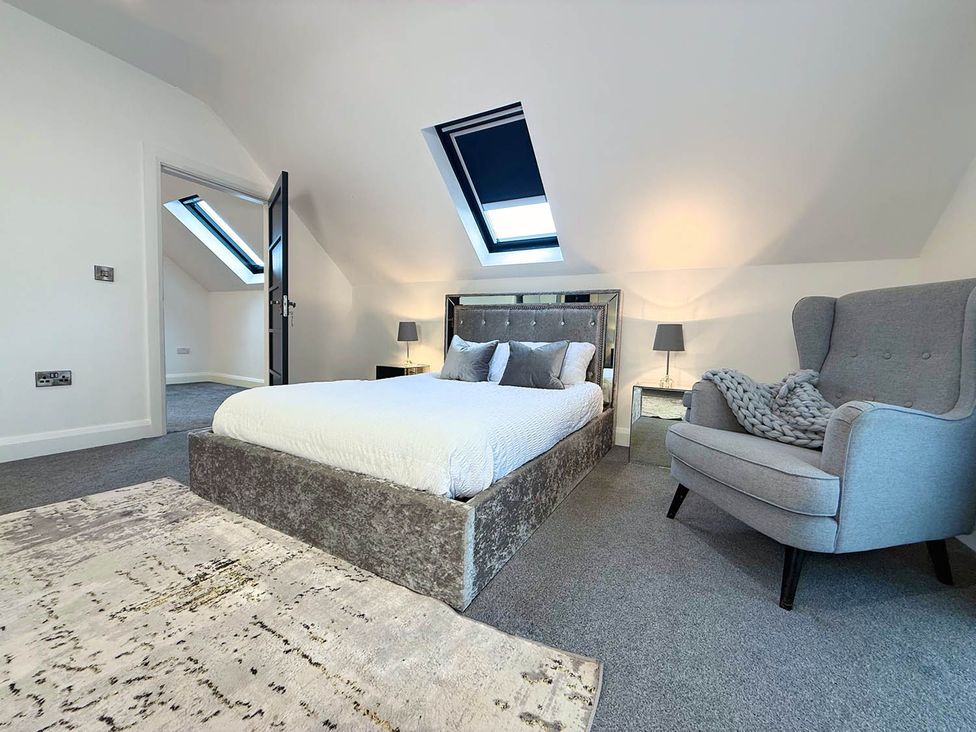 A bedroom with a bed, armchair and skylights at Jeannies retreat at little lake fb