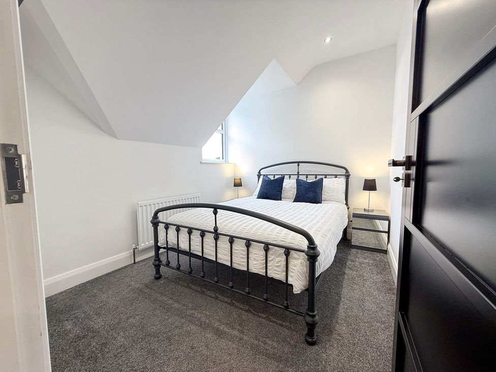 A bedroom with a bed and bedside table at Jeannies retreat at little lake fb