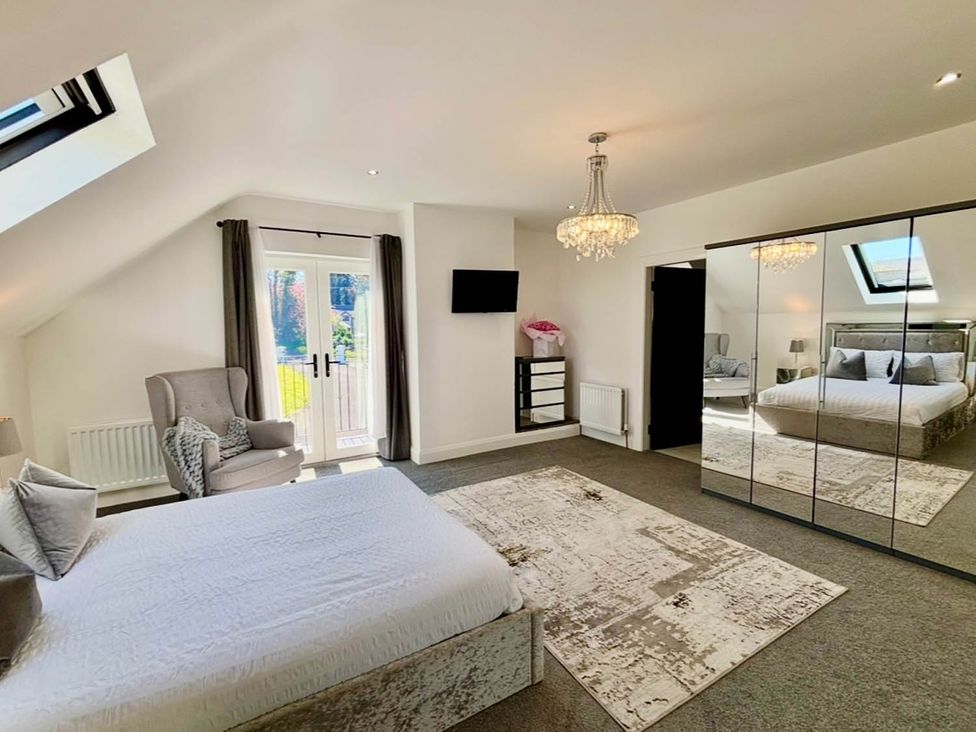 A bedroom with a bed and an armchair at Jeannies retreat at little lake fb