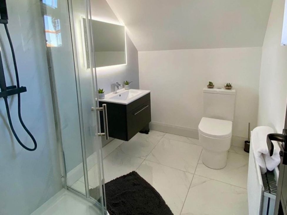 A bathroom with a sink, toilet, and shower at Jeannies retreat at little lake fb