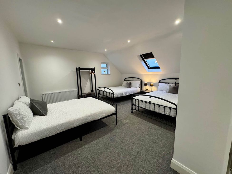 A bedroom with multiple beds and a radiator at Jeannies retreat at little lake fb