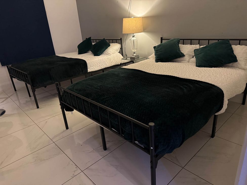A bedroom with two beds and a lamp at Jeannies retreat at little lake fb