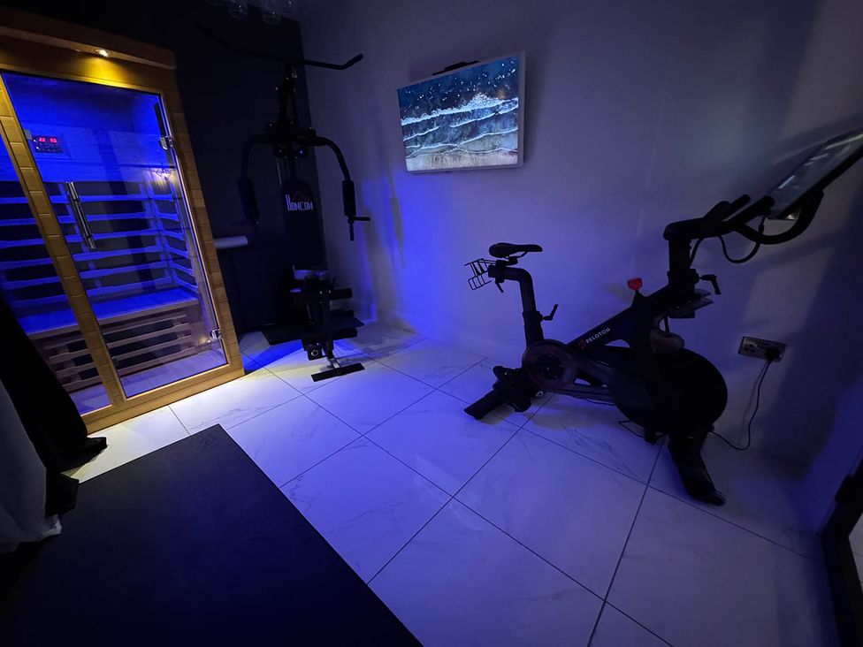 A gym with a sauna, exercise bike, and weight machine at Jeannies retreat at little lake fb