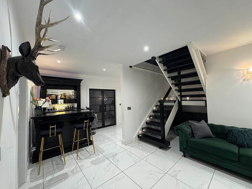 A living room with a bar and staircase at Jeannies retreat at little lake fb