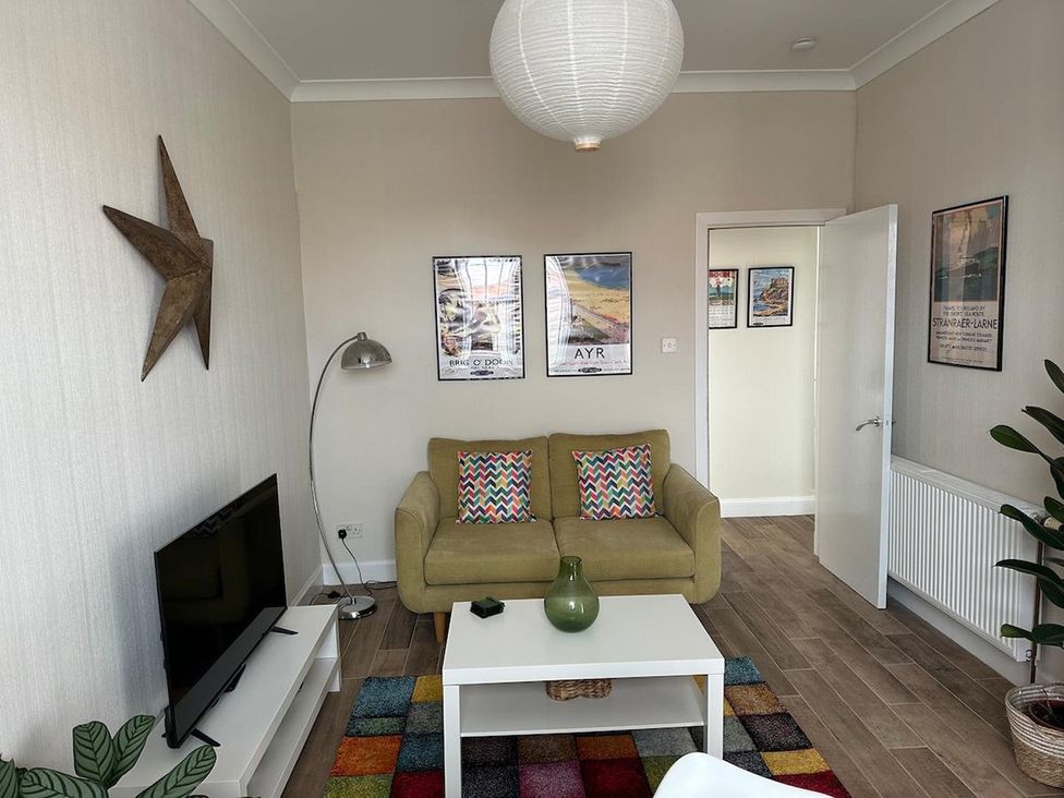A living room with a sofa and television at the property in location