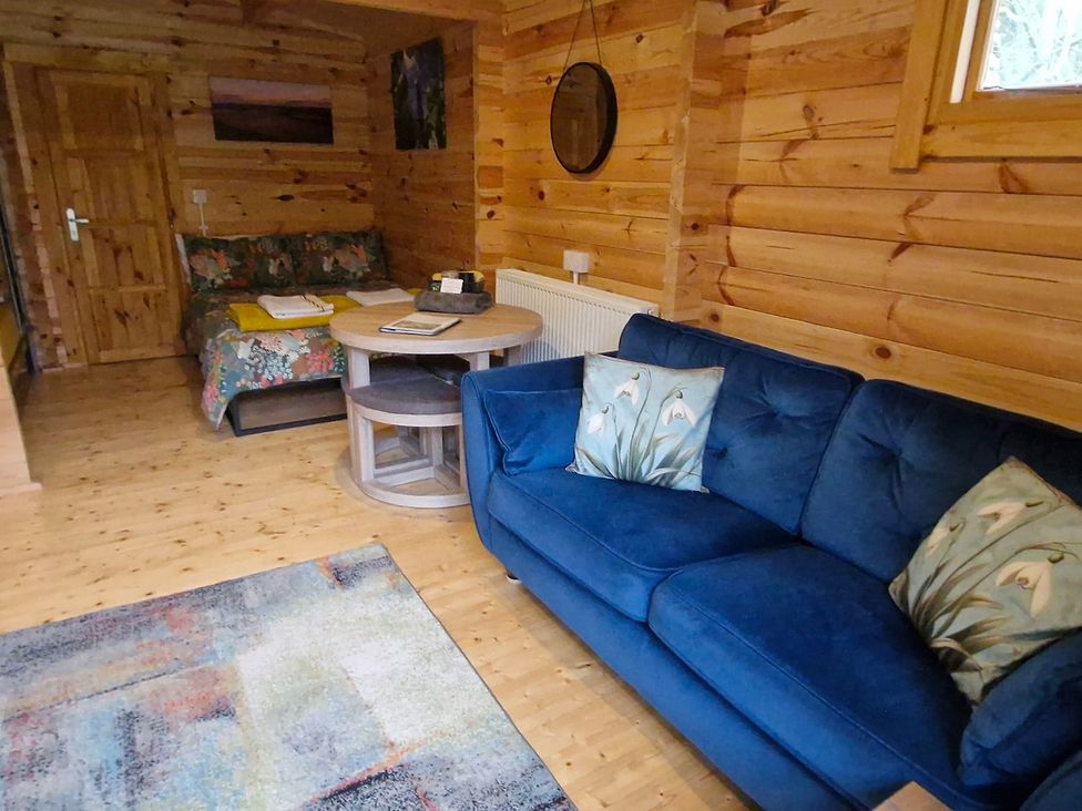 A living room with a sofa and coffee table at Snowdrop Lodge Dog friendly Nr Anderby Creek in Alford