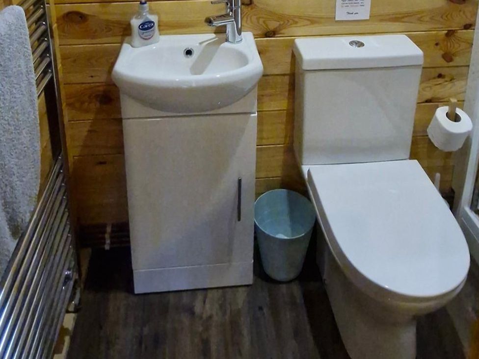 A bathroom with a sink and toilet at Snowdrop Lodge Dog friendly Nr Anderby Creek, Alford
