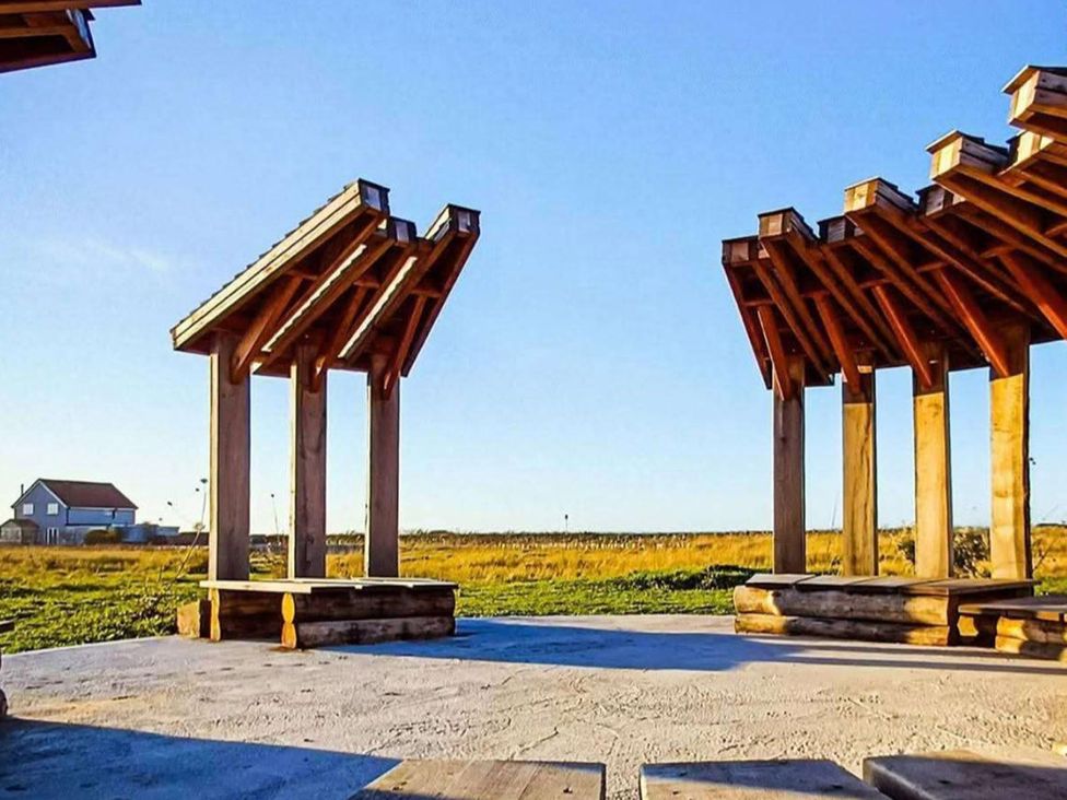 Wooden pergola structures in an outdoor area at Snowdrop Lodge Dog friendly Nr Anderby Creek Alford