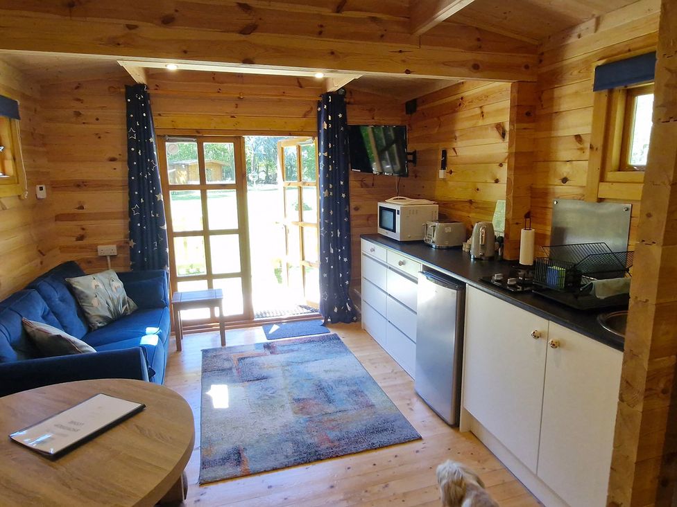 A kitchen with a sofa and table at Snowdrop Lodge Dog friendly Nr Anderby Creek Alford