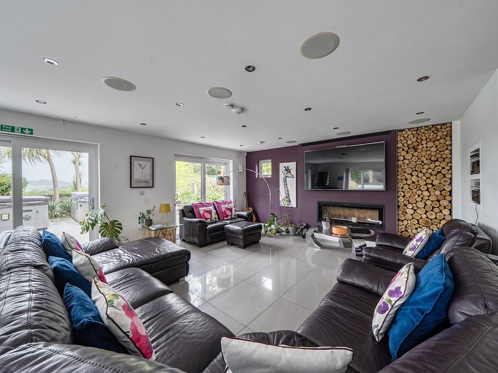 A living room with sofas and a television at 5 Bed House, Sleeps 14 with Hot Tub and Bar in Tavistock