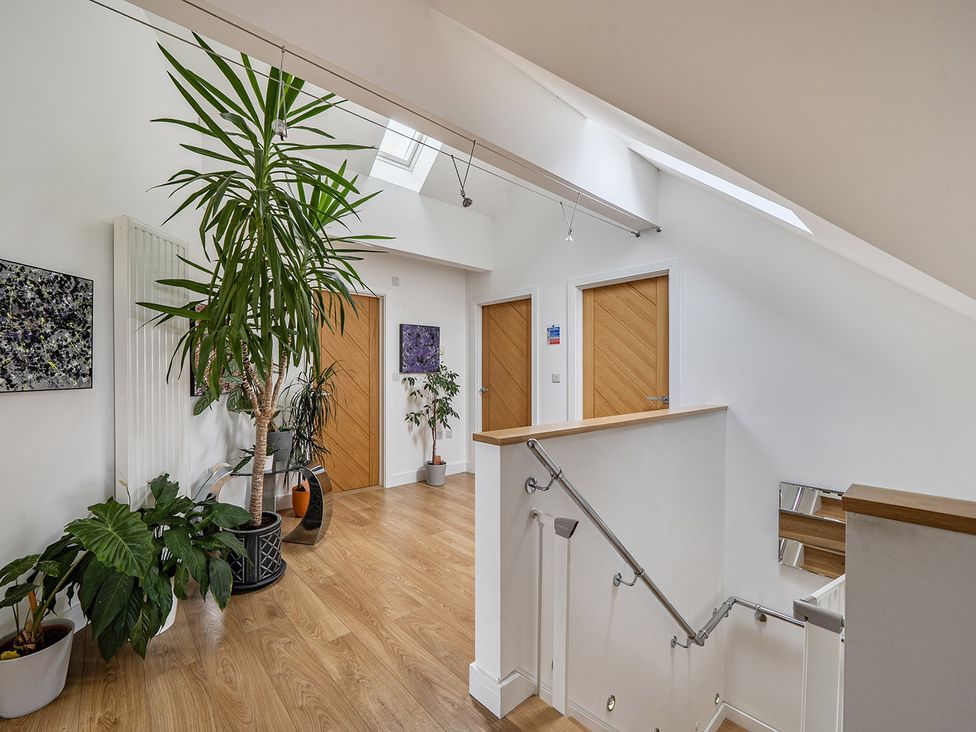 A hallway with plants and doors at 5 Bed House, Sleeps 14 with Hot Tub and Bar, Tavistock