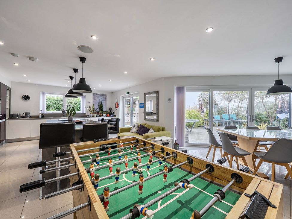 A kitchen with a foosball table and dining area at 5 Bed House, Sleeps 14 with Hot Tub and Bar, Tavistock