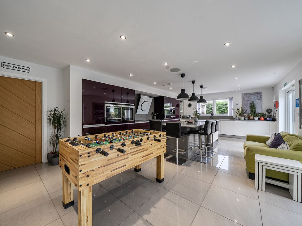 A kitchen with a foosball table and island seating at 5 Bed House, Sleeps 14 with Hot Tub and Bar Tavistock