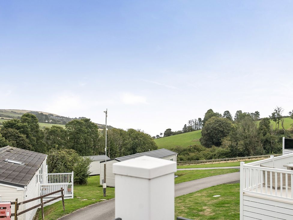 A landscape view with caravans and trees at Ty dee seaview escapes Looe