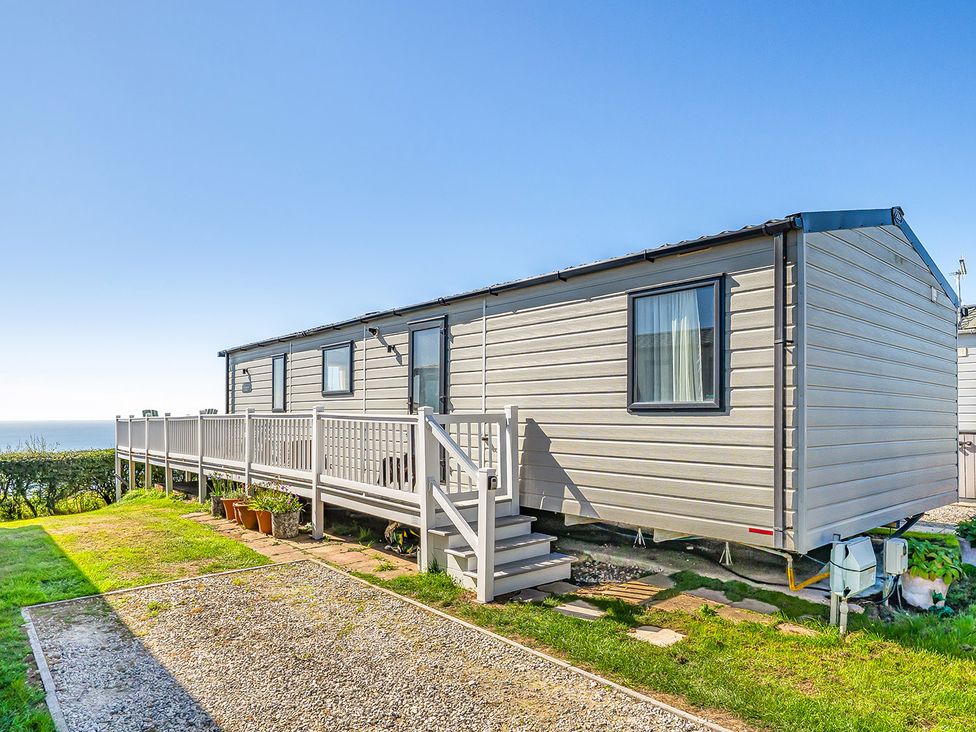 A caravan with a deck and stairs at 2 Bed Caravan, Sleeps 4 with Sea Views, West Lulworth