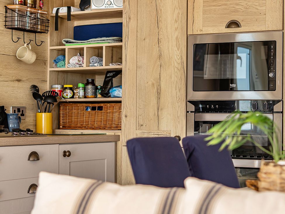 A kitchen with a microwave and oven at 2 Bed Caravan, Sleeps 4 with Sea Views in West Lulworth