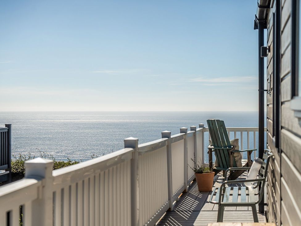 A deck with chairs and a view of the sea at 2 Bed Caravan, Sleeps 4 with Sea Views, West Lulworth