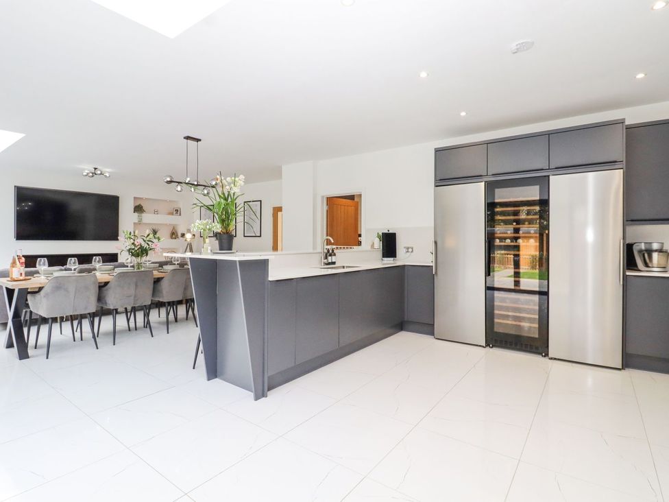 A kitchen with a dining area and modern appliances at Berisal in Ashford