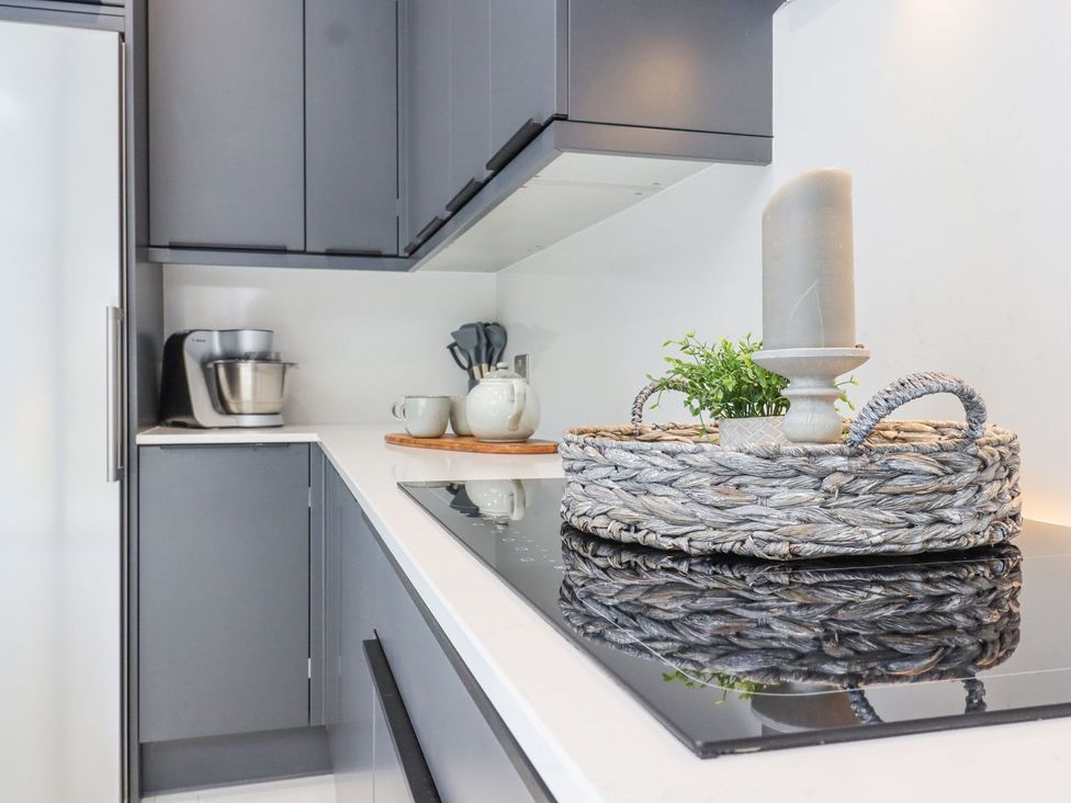 A kitchen with a cooking stove and utensils at Berisal in Ashford