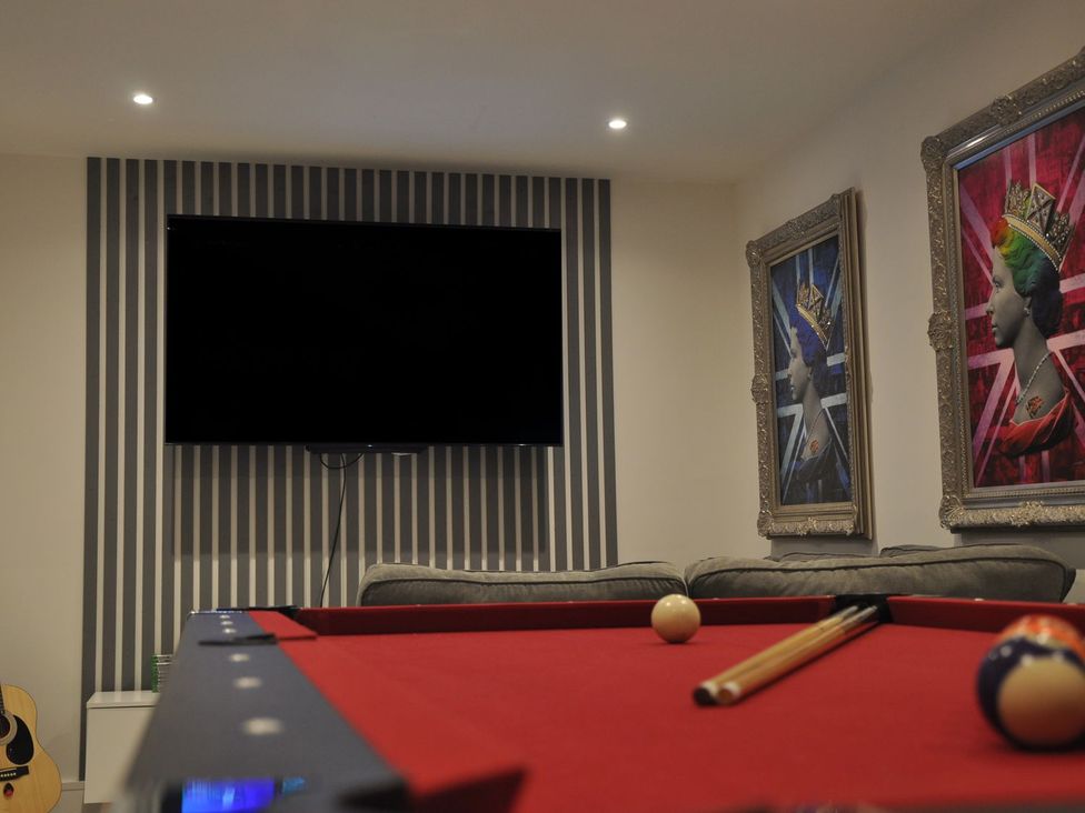 A game room with a pool table and a television at Berisal in Ashford