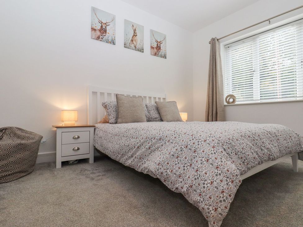 A bedroom with a bed and nightstand at Berisal in Ashford
