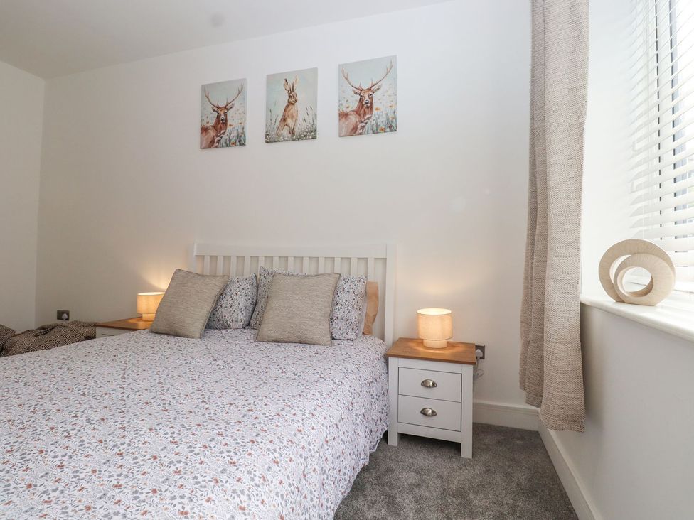 A bedroom with a bed and bedside table at Berisal, Ashford