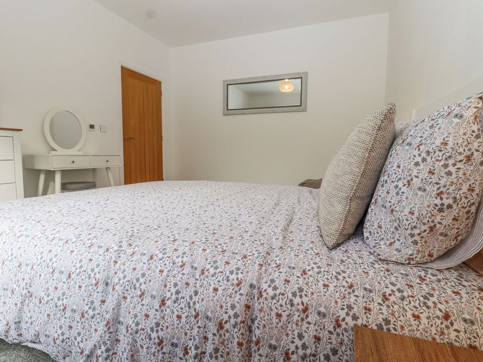 A bedroom with a bed and a mirror at Berisal in Ashford
