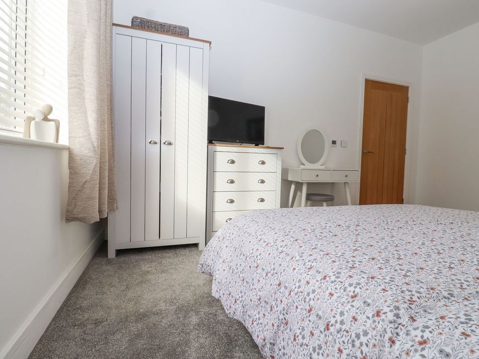 A bedroom with a bed and wardrobe at Berisal in Ashford