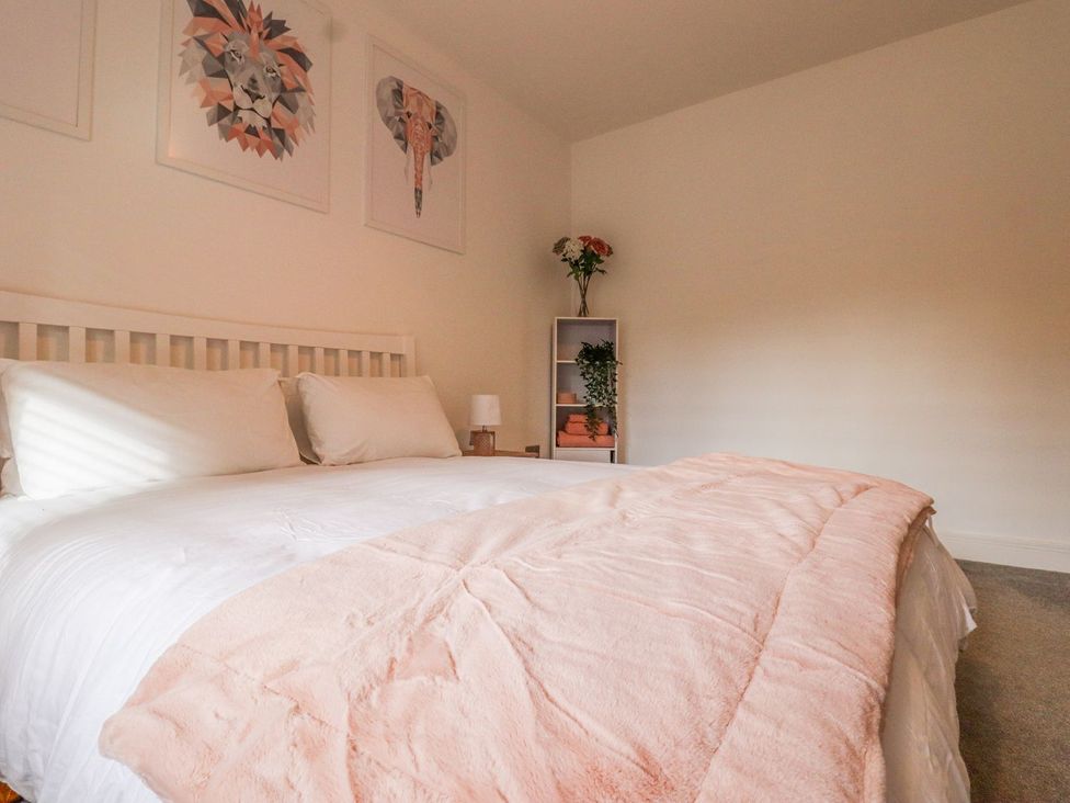 A bedroom with a bed and decorative shelf at Berisal in Ashford