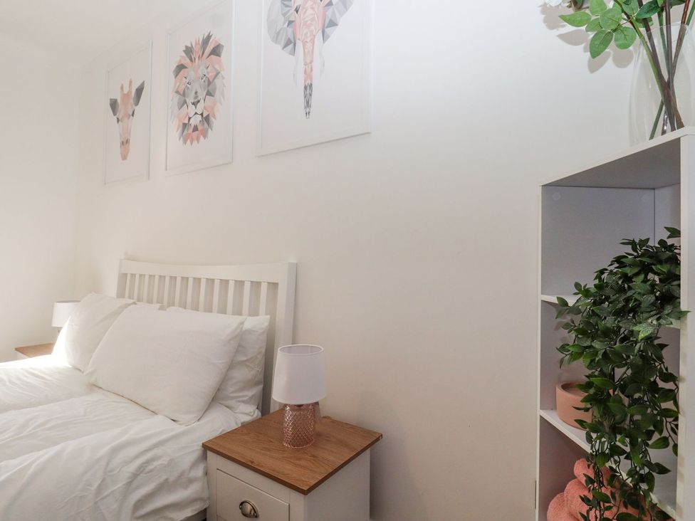 A bedroom with a bed and wall art at Berisal in Ashford