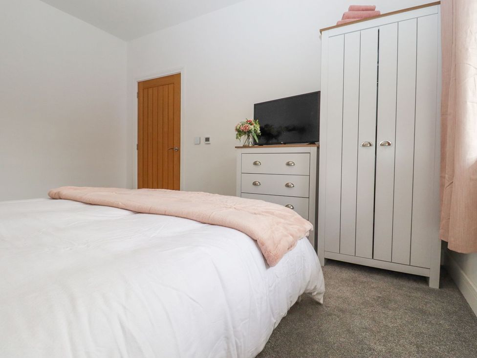 A bedroom with a bed and wardrobe at Berisal in Ashford