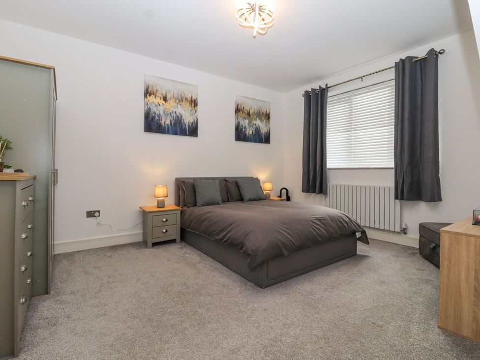 A bedroom with a bed and artwork at Berisal in Ashford