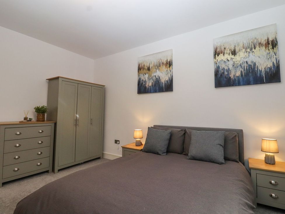 A bedroom with a bed and storage furniture at Berisal in Ashford
