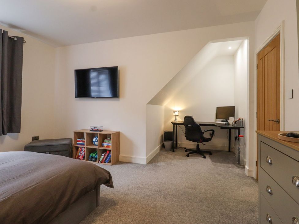 A bedroom with a bed and a workspace at Berisal in Ashford