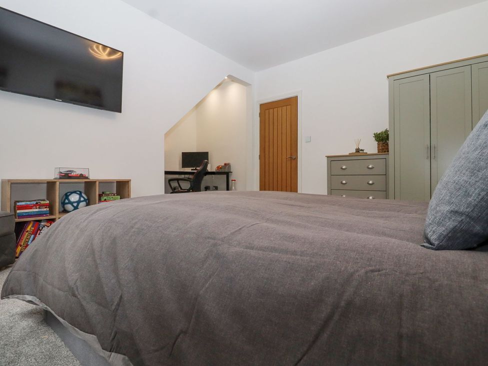 A bedroom with a television and a dresser at Berisal in Ashford