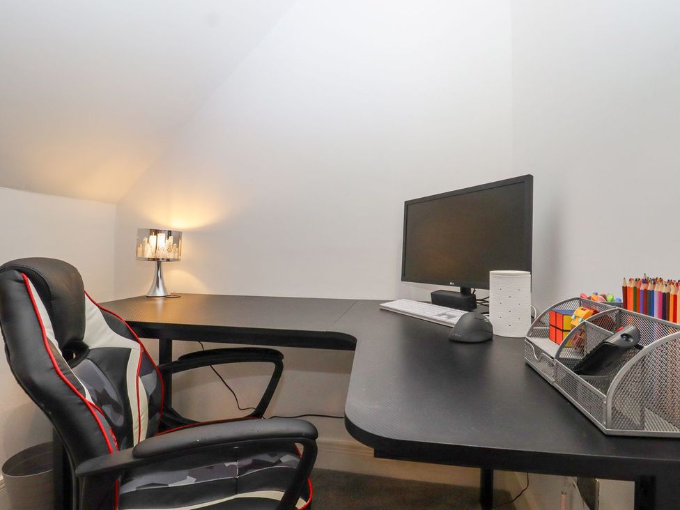 An office with a desk and computer setup at Berisal in Ashford