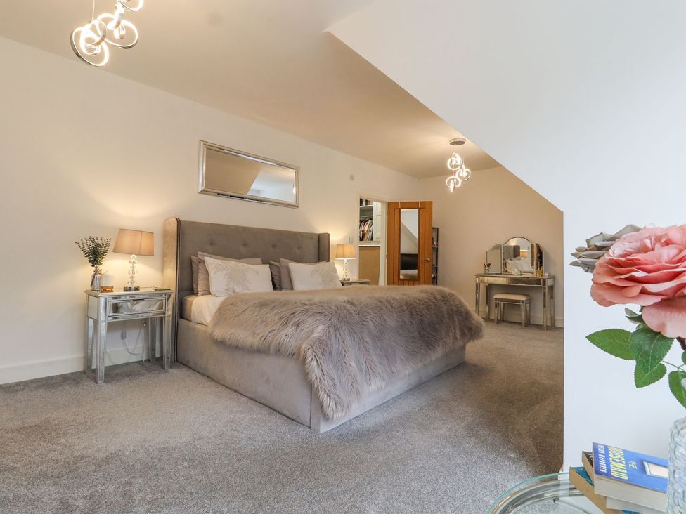 A bedroom with a bed and dressing table at Berisal in Ashford