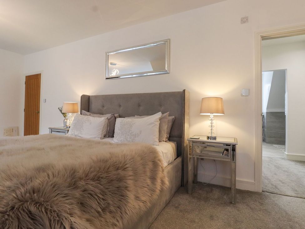 A bedroom with a bed and bedside table at Berisal in Ashford