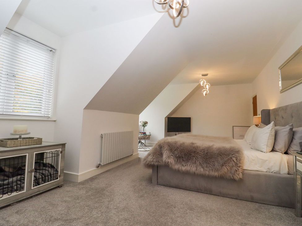 A bedroom with a bed and television at Berisal in Ashford