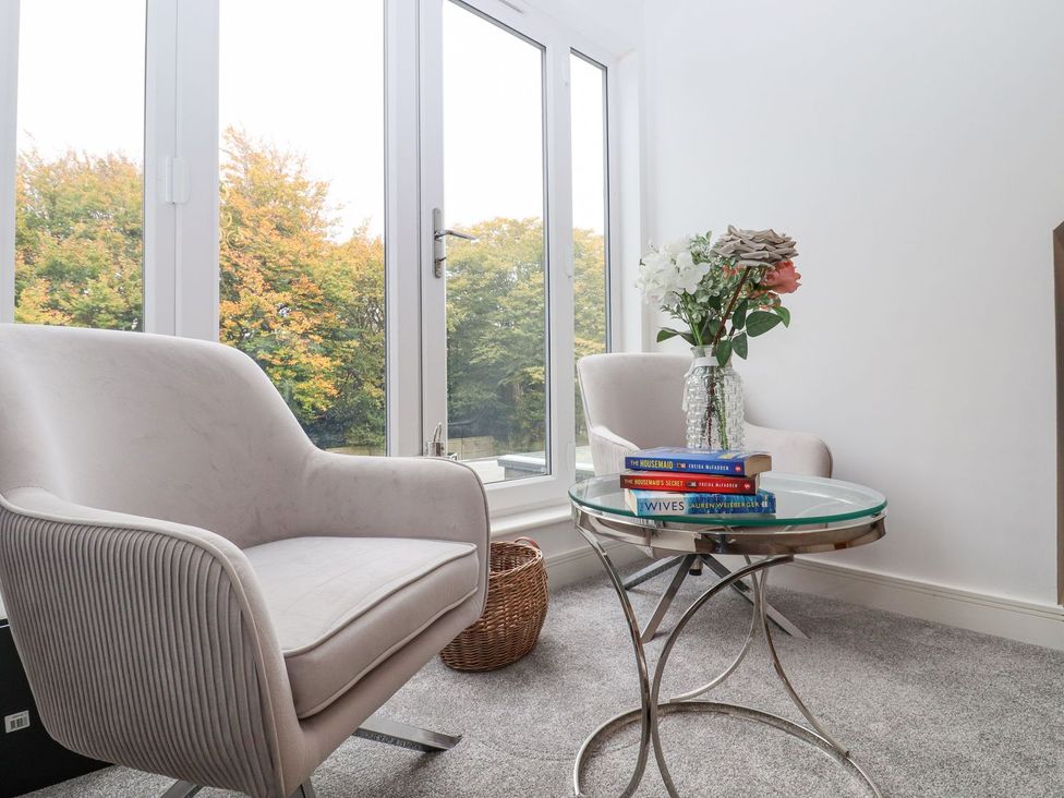 A snug with armchairs and a coffee table at Berisal in Ashford