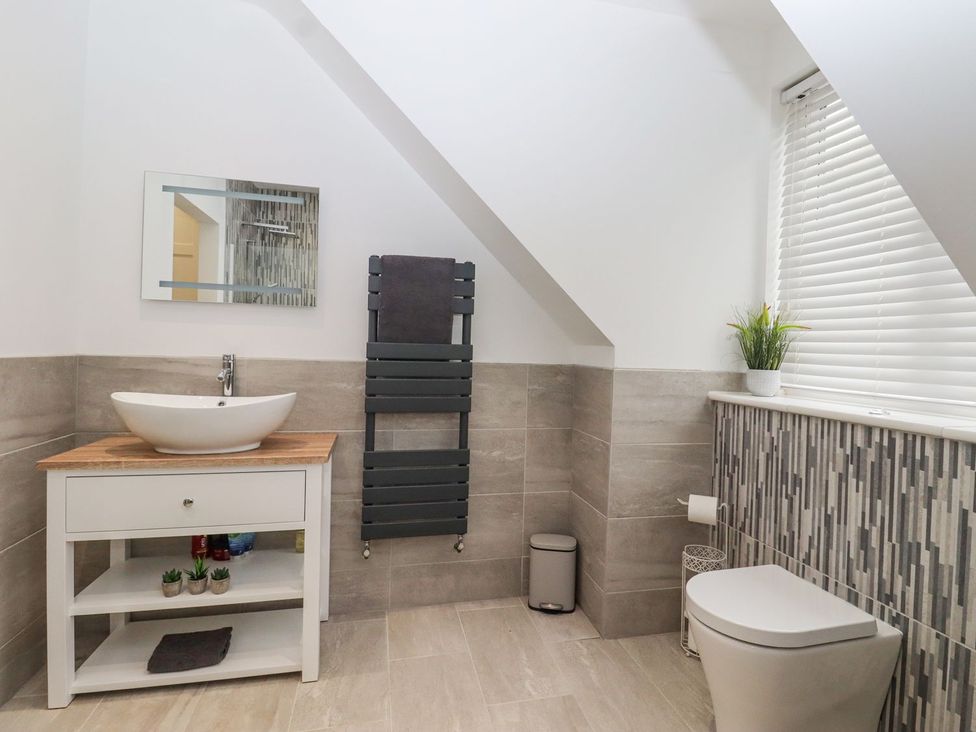 A bathroom with a wash basin and towel rack at Berisal in Ashford