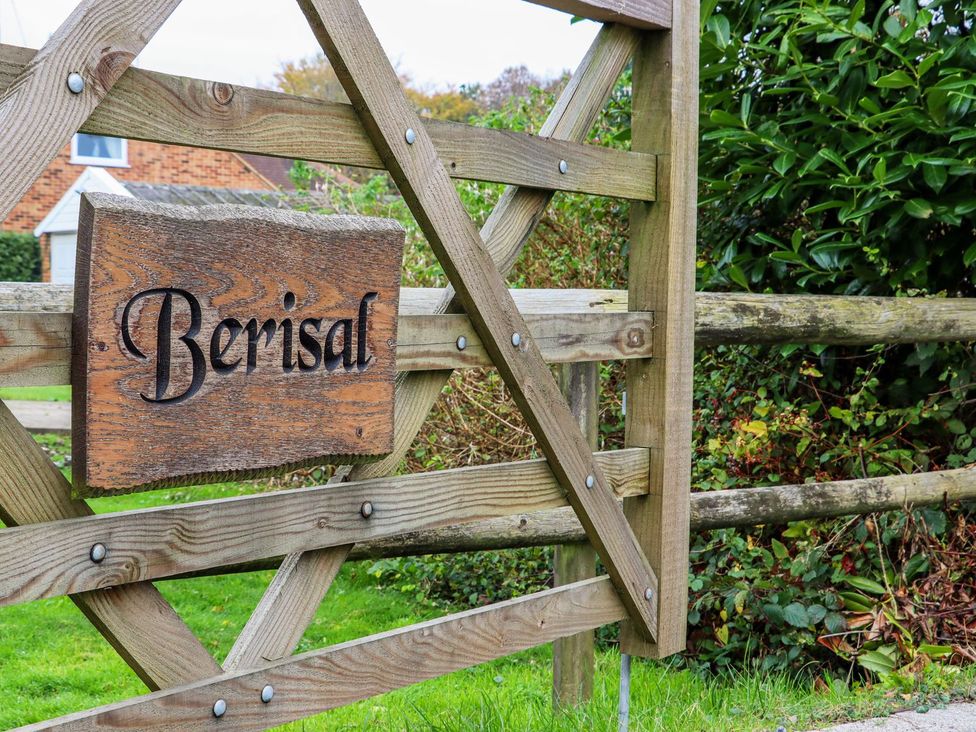 A wooden gate with a sign that says Berisal at Berisal in Ashford