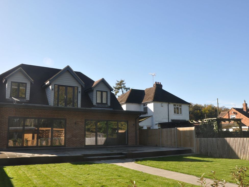 A house with a garden and decking at Berisal Ashford